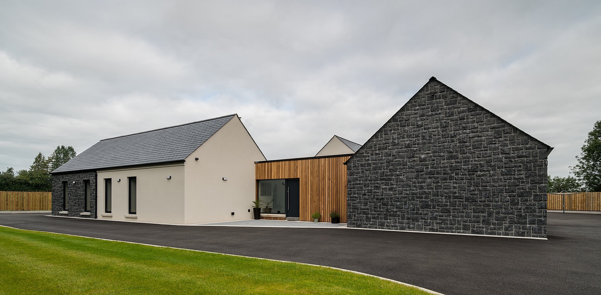 modern house frontage with timber cladding and stone walls